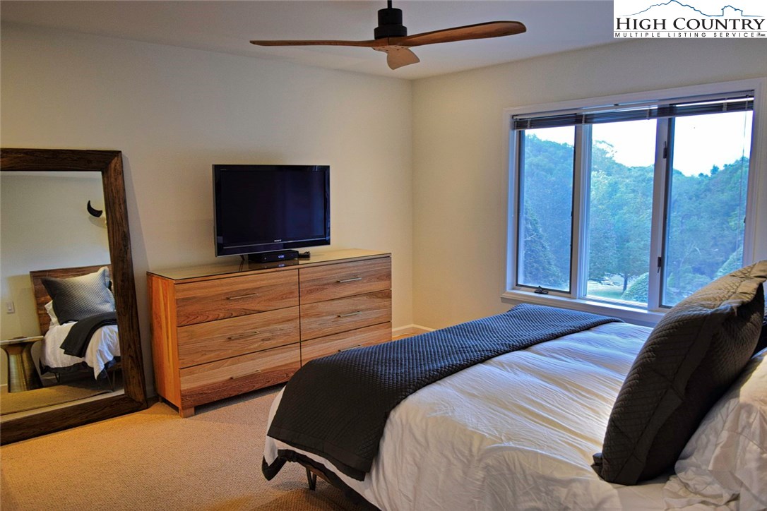 250 Ascot Lane Boone, NC 28607 - Photo 23 of 44 a bedroom with a bed and a flat screen tv