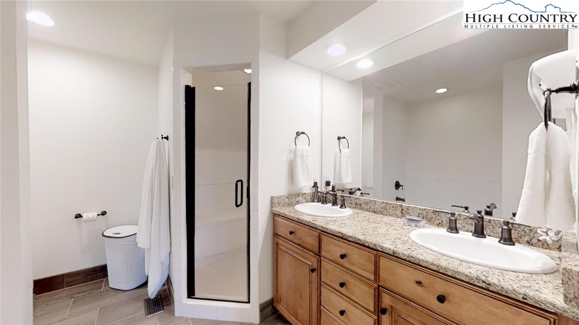 250 Ascot Lane Boone, NC 28607 - Photo 32 of 44 a bathroom with a double vanity sink toilet and a mirror