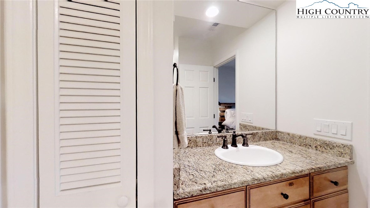 250 Ascot Lane Boone, NC 28607 - Photo 35 of 44 a bathroom with a granite countertop sink and a mirror