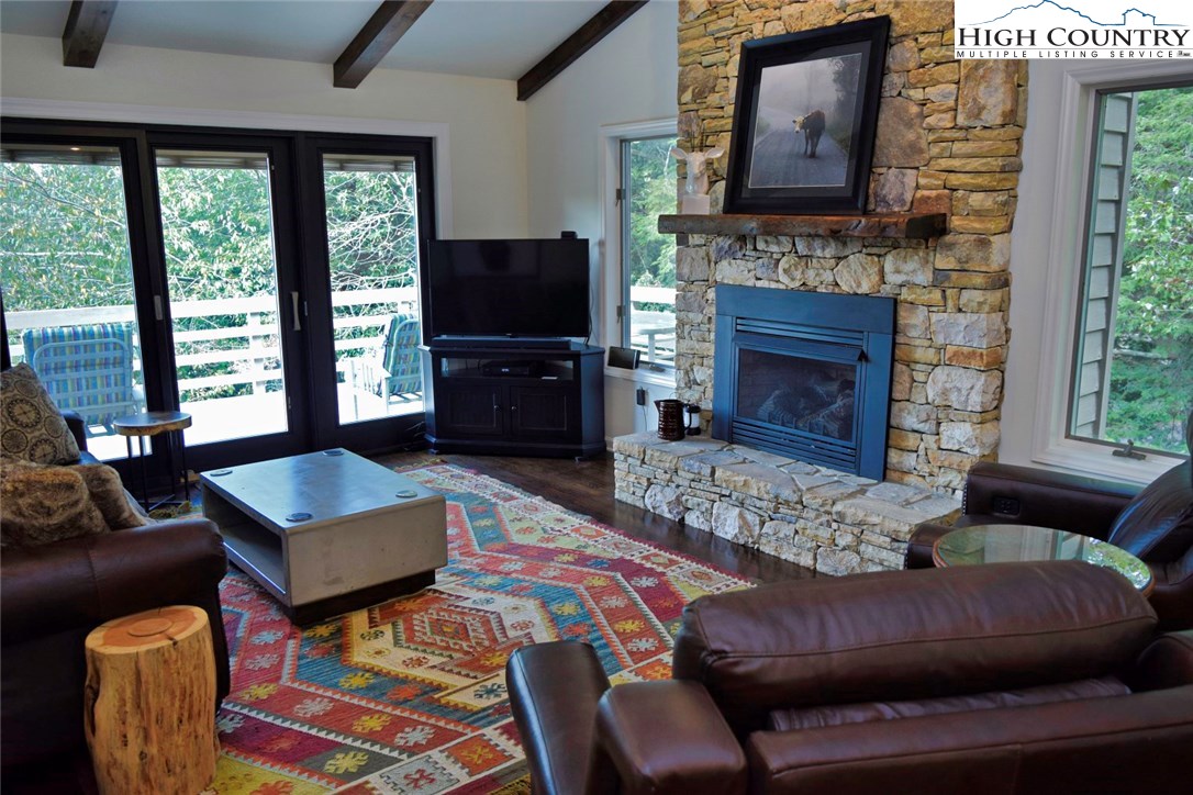 250 Ascot Lane Boone, NC 28607 - Photo 7 of 44 a living room with furniture a flat screen tv and a fireplace
