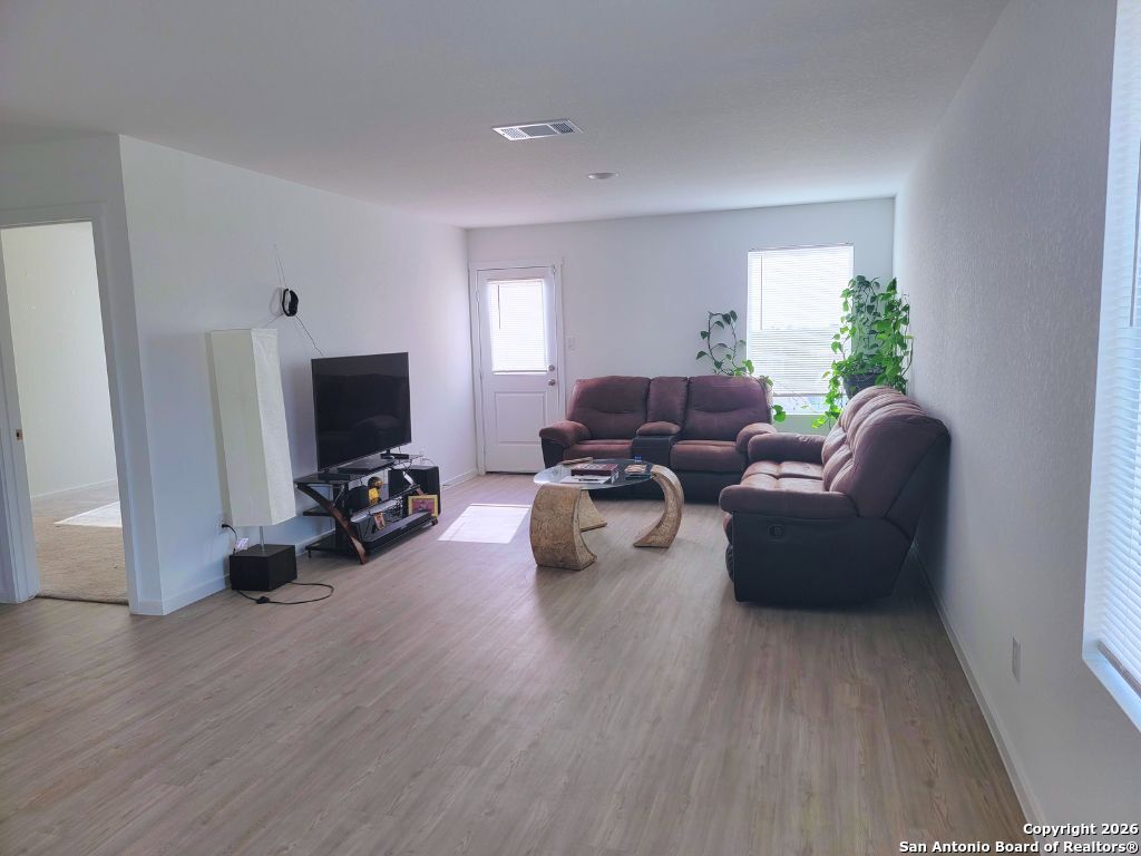 3703 Millbrook Way San Antonio, TX 78245 - Photo 4 of 10 a living room with furniture and a flat screen tv