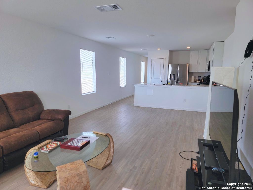 3703 Millbrook Way San Antonio, TX 78245 - Photo 5 of 10 a living room with furniture and a wooden floor