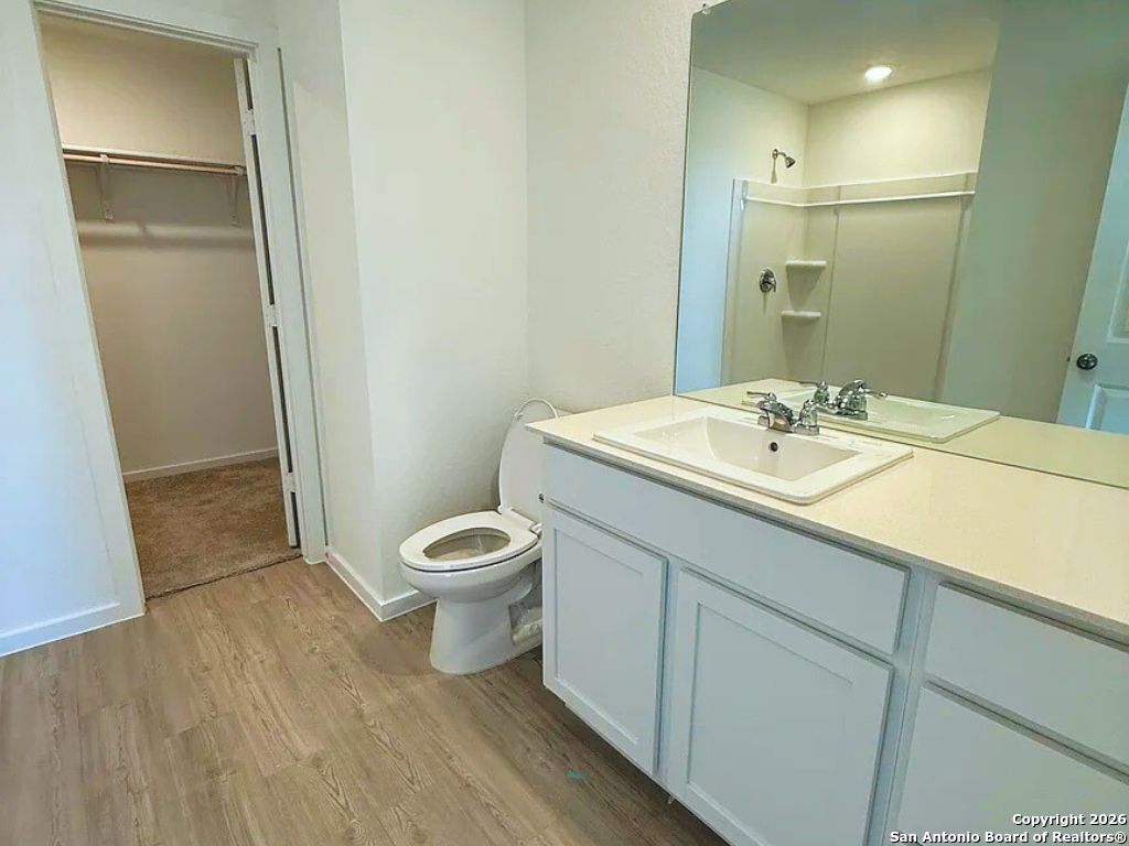 3703 Millbrook Way San Antonio, TX 78245 - Photo 6 of 10 a bathroom with a sink toilet and shower