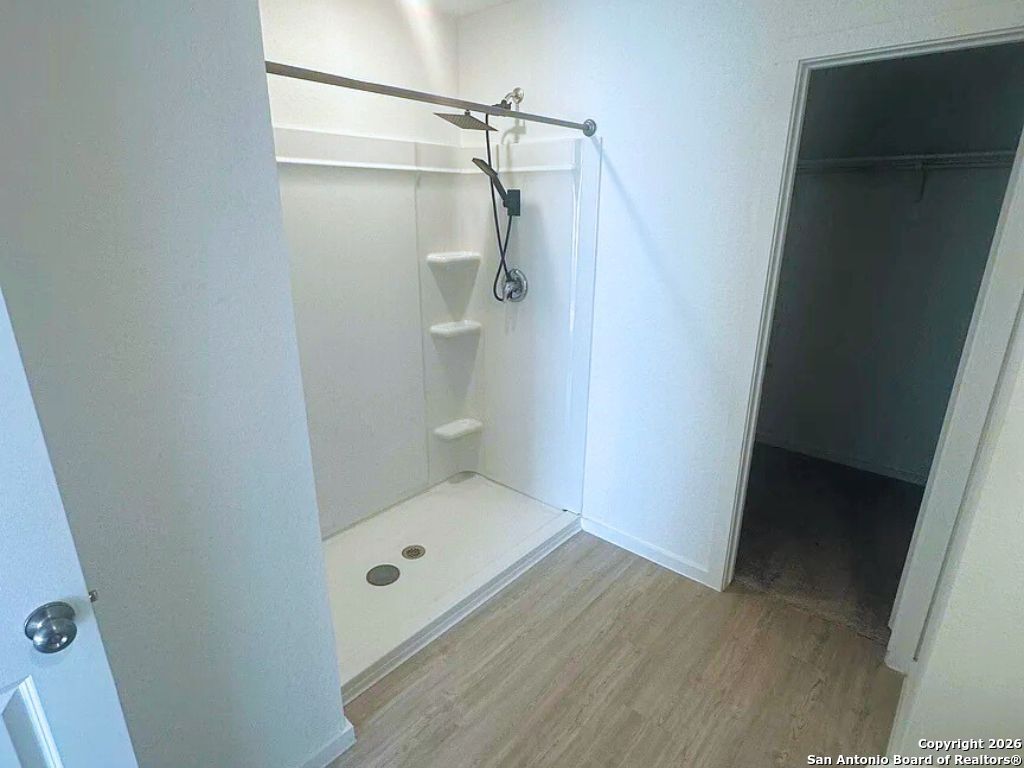3703 Millbrook Way San Antonio, TX 78245 - Photo 7 of 10 a bathroom with a shower and toilet