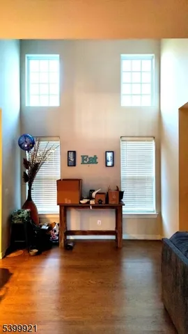 a bedroom with furniture and a wooden floor
