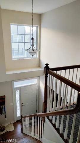 a view of staircase with white walls and a window