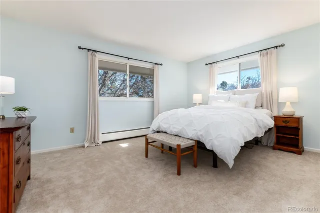 a bedroom with a bed and a painting on the wall