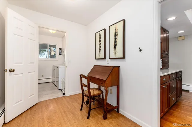 a view of a workspace with furniture and wooden floor