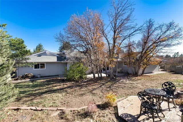 a view of a backyard with a tree