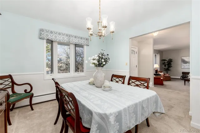 a view of a dining room with furniture and a chandelier