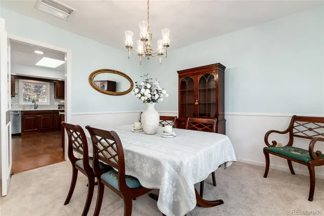 a view of a dining room with furniture and chandelier