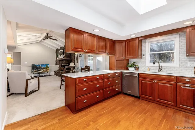 a kitchen with stainless steel appliances granite countertop a stove a sink dishwasher and a refrigerator