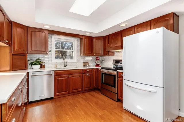 a kitchen with stainless steel appliances granite countertop a refrigerator sink and cabinets