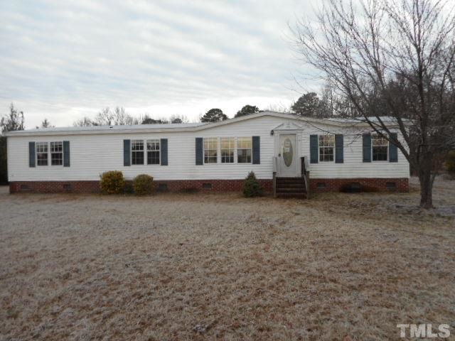 8124 Wiggins Mill Road Lucama, NC 27851 - Photo 1 of 12 a view of a house with a backyard