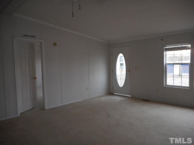 8124 Wiggins Mill Road Lucama, NC 27851 - Photo 3 of 12 an empty room with windows and mirror