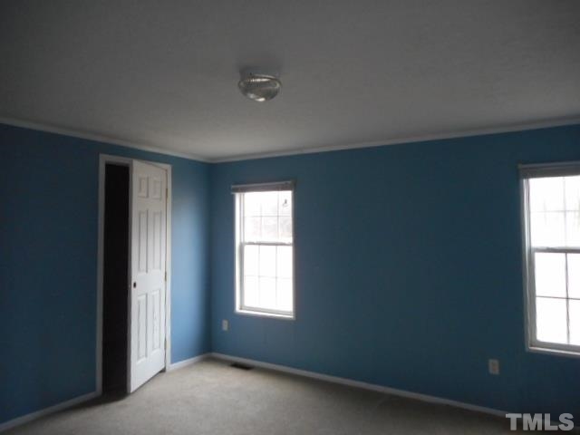 8124 Wiggins Mill Road Lucama, NC 27851 - Photo 7 of 12 an empty room with a window