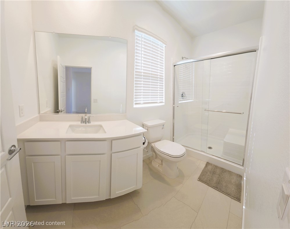 509 Arthur Pointe Street Henderson, NV 89011 - Photo 14 of 14 Bathroom featuring vanity, a stall shower, and light tile patterned floors
