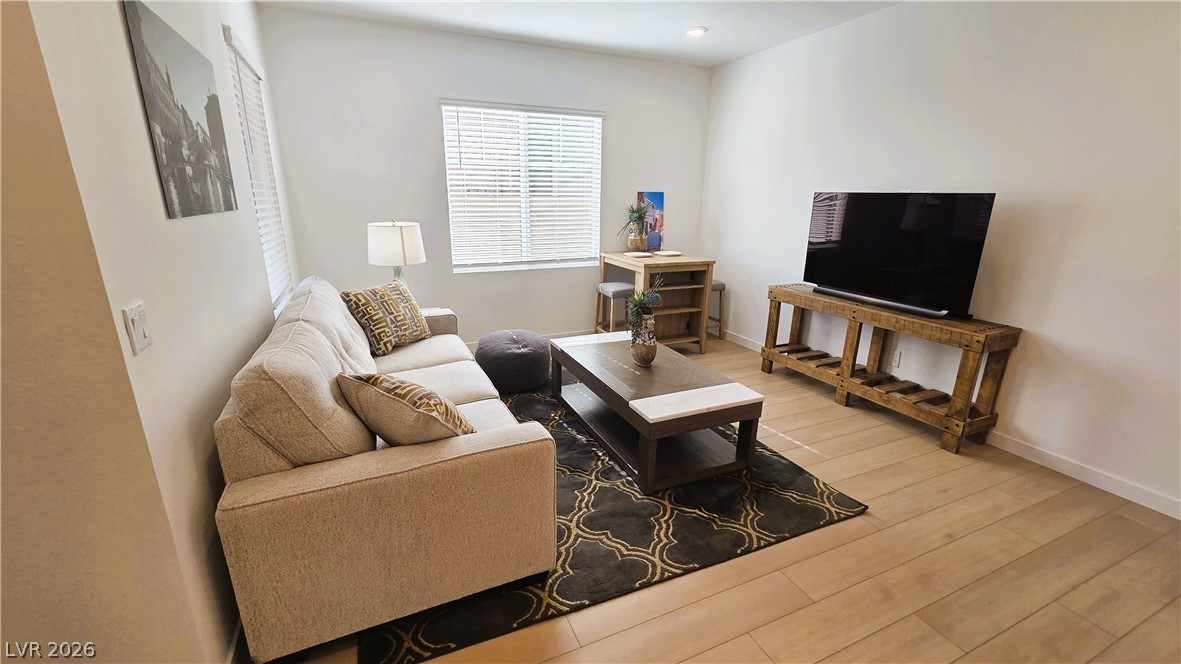 509 Arthur Pointe Street Henderson, NV 89011 - Photo 8 of 14 Living area featuring light wood finished floors and baseboards