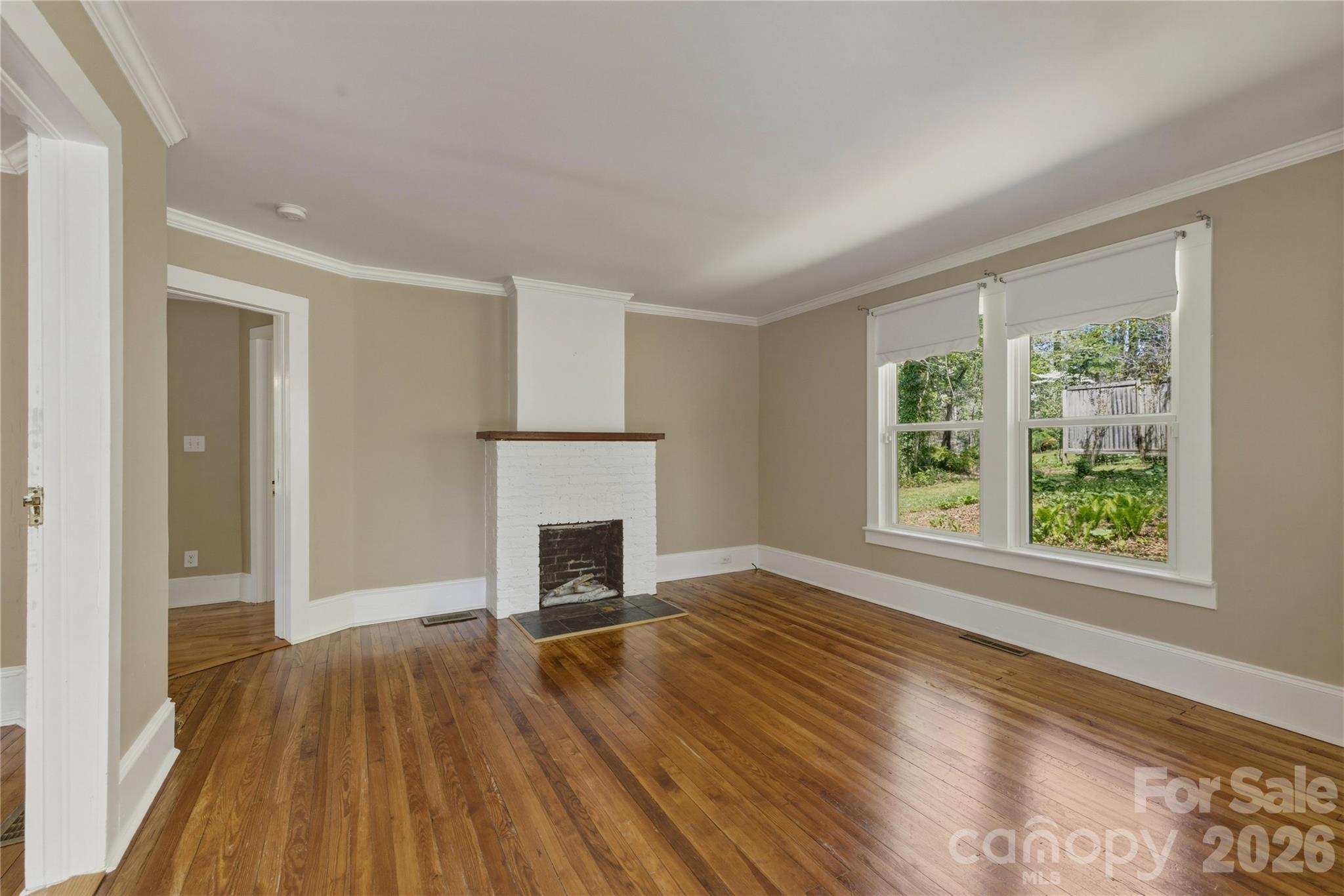 512 Alexander Avenue Morganton, NC 28655 - Photo 8 of 29 a view of empty room with wooden floor and fireplace