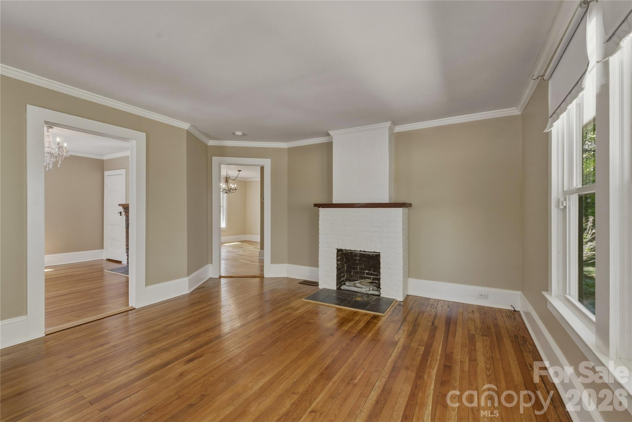 512 Alexander Avenue Morganton, NC 28655 - Photo 9 of 29 a view of empty room with wooden floor and fireplace
