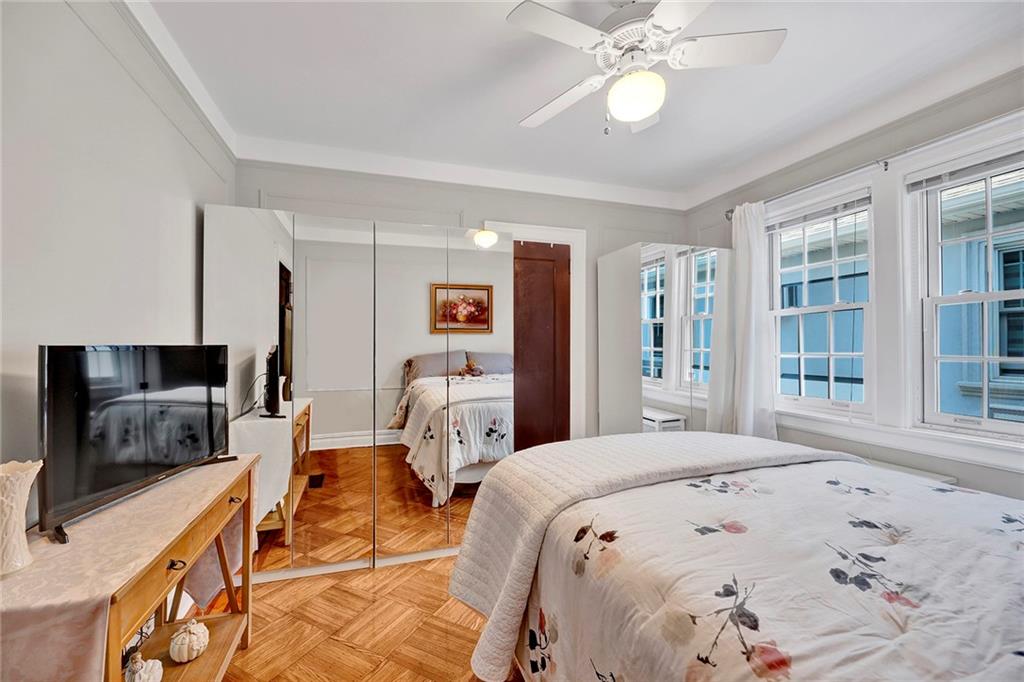7607 Colonial Road Brooklyn, NY 11209 - Photo 19 of 35 a bedroom with a bed and a flat screen tv