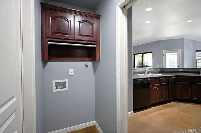 a kitchen with granite countertop a stove top oven and sink