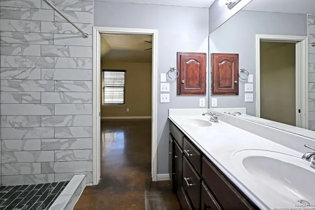 a en suite bathroom with a sink and mirror