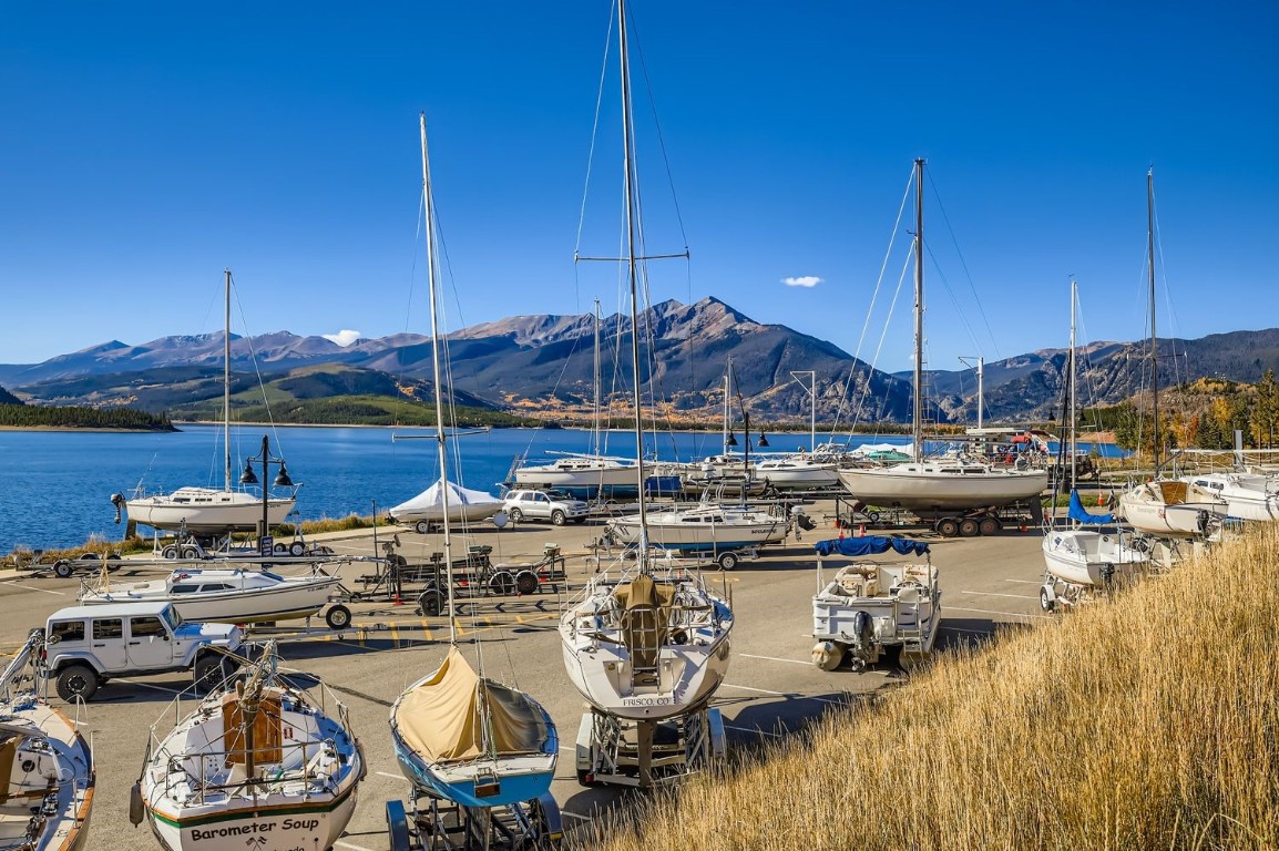 160 La Bonte Street, Unit 306 Dillon, CO 80435 - Photo 28 of 47 a view of a lake with chairs and umbrellas