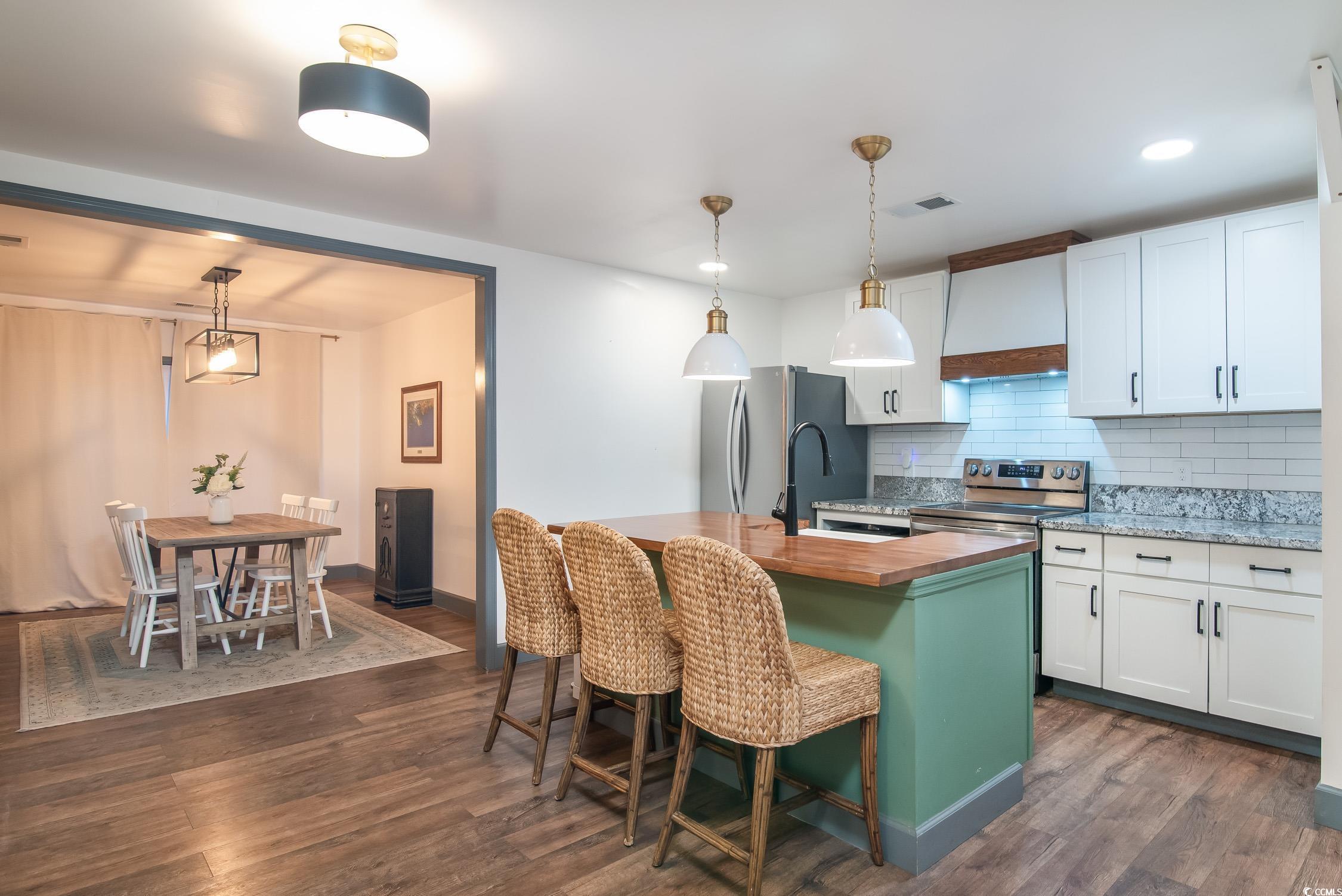 1714 Oak Street Georgetown, SC 29440 - Photo 11 of 40 Kitchen featuring white cabinetry, a kitchen islan