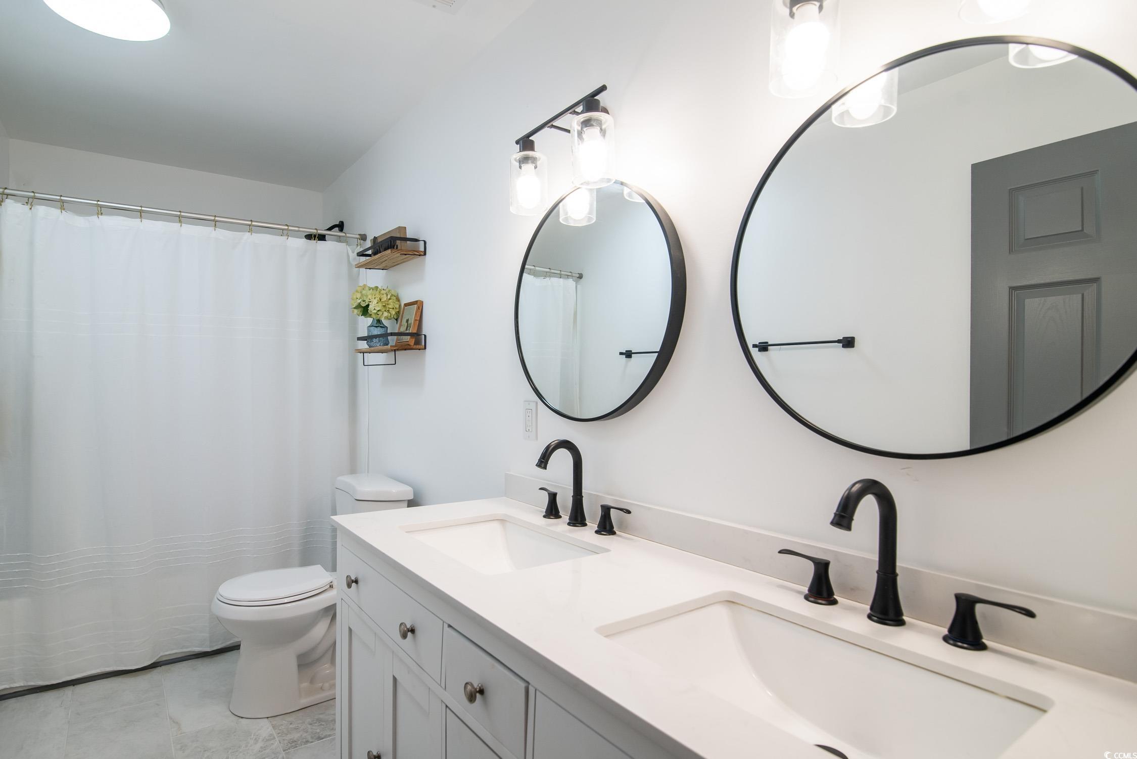 1714 Oak Street Georgetown, SC 29440 - Photo 20 of 40 Bathroom featuring vanity, toilet, and walk in sho