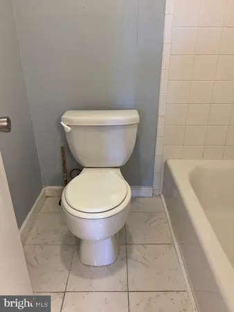 a bathroom with a toilet and a bathtub