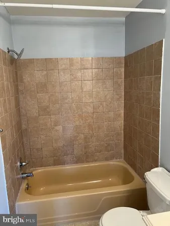 a view of a bathroom with bathtub and shower