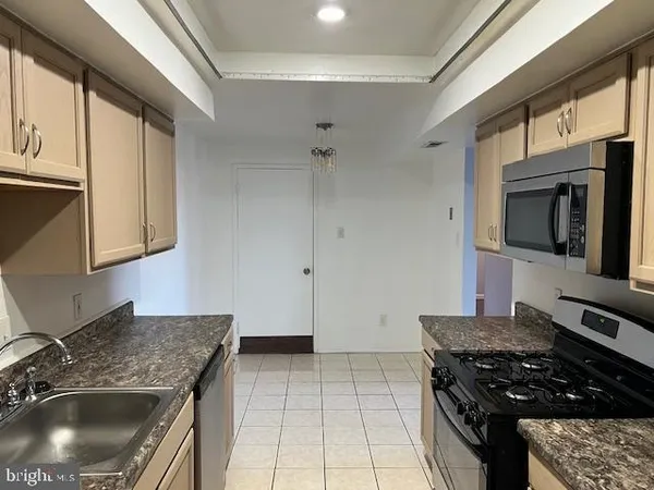 a kitchen with granite countertop a stove and a sink