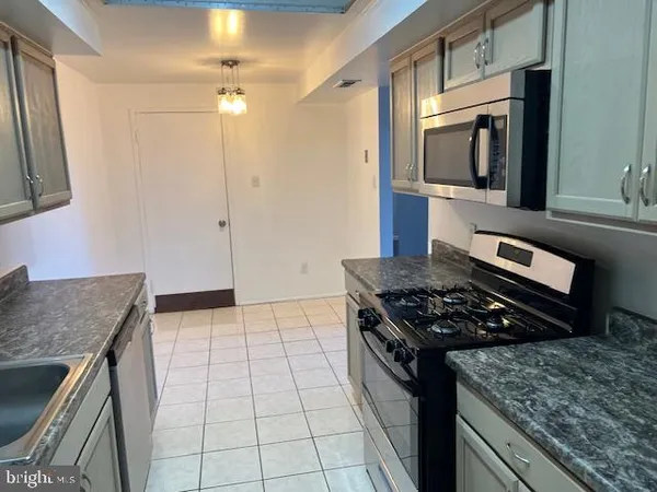 a kitchen with a stove and a microwave