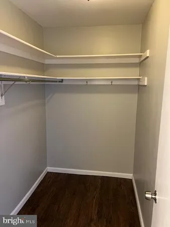 a view of a room with wooden floor