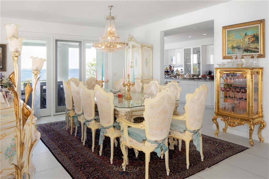 14040 Schultz Road Fort Myers, FL 33908 - Photo 24 of 48 Dining area featuring light tile patterned floors and a chandelier