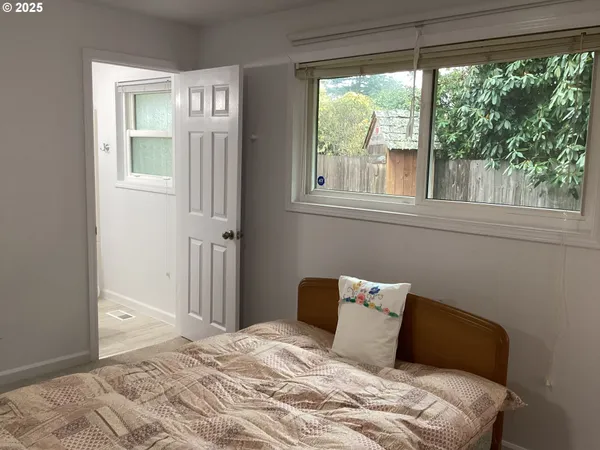 a bedroom with a bed and a window