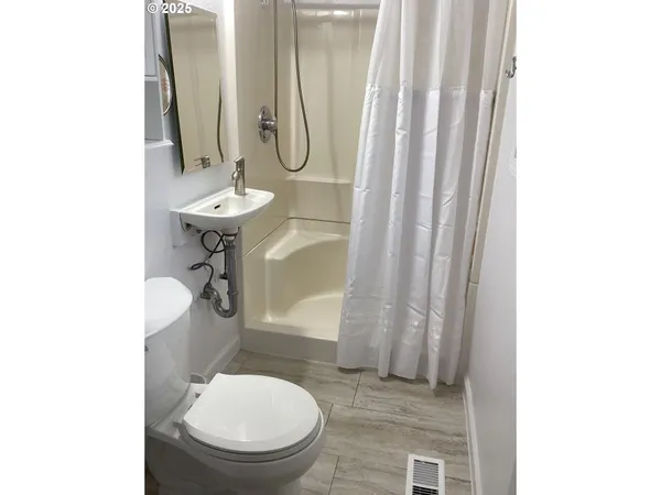 a bathroom with a toilet a sink and a mirror