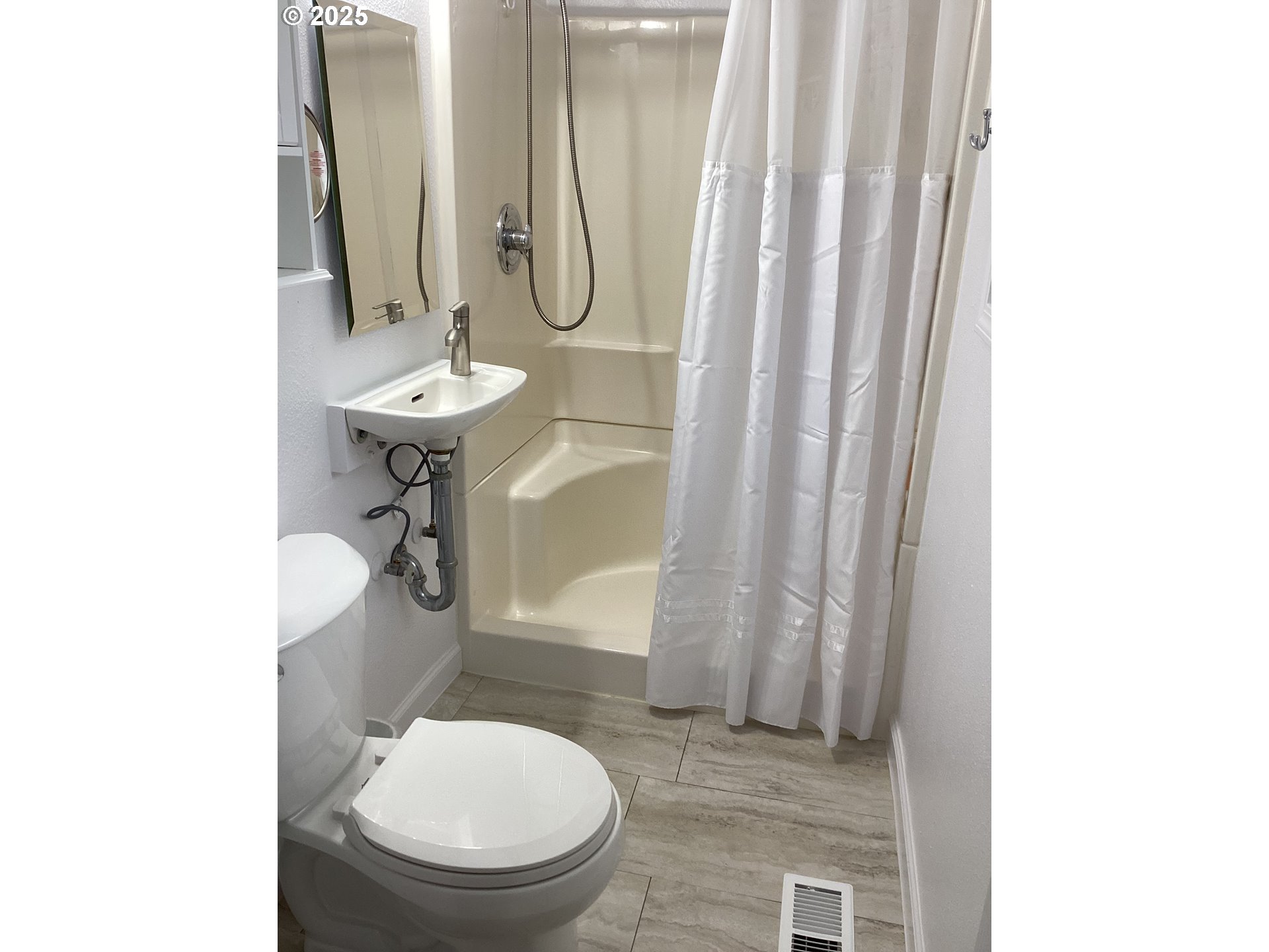 17706 Southeast Washington Street Portland, OR 97233 - Photo 16 of 34 a bathroom with a toilet a sink and a mirror