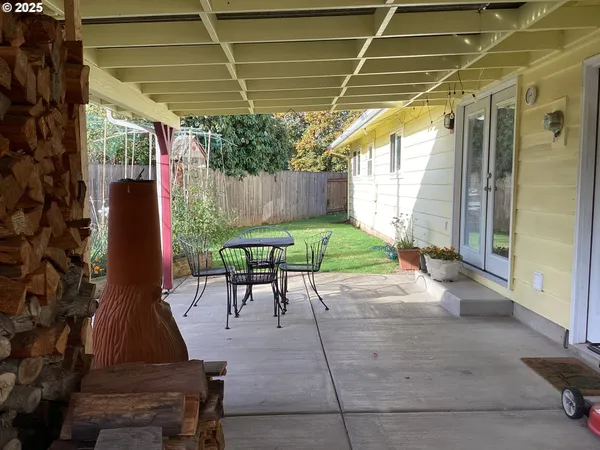 a patio with table and chairs