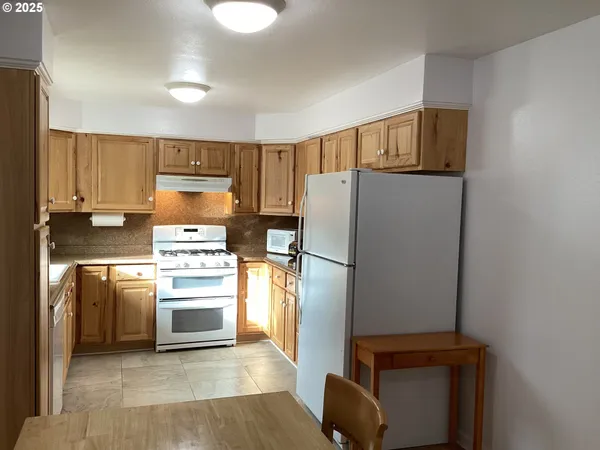 a kitchen with a refrigerator sink and stove
