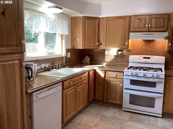 a kitchen with a stove and a sink