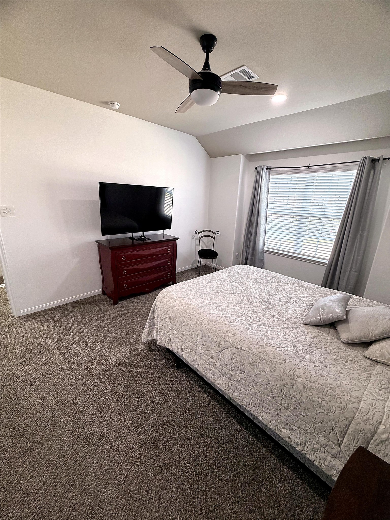 18623 Dingo Stream Lane Katy, TX 77449 - Photo 14 of 29 a bedroom with a bed and a flat screen tv