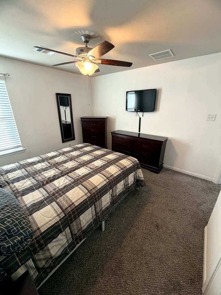 18623 Dingo Stream Lane Katy, TX 77449 - Photo 24 of 29 a bedroom with a bed and a night stand