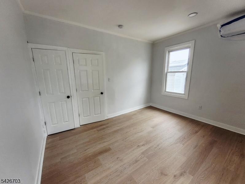 49 Union Place, Unit 3 Irvington, NJ 07111 - Photo 12 of 20 a view of empty room with wooden floor and fan