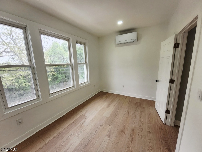 49 Union Place, Unit 3 Irvington, NJ 07111 - Photo 15 of 20 an empty room with wooden floor and windows