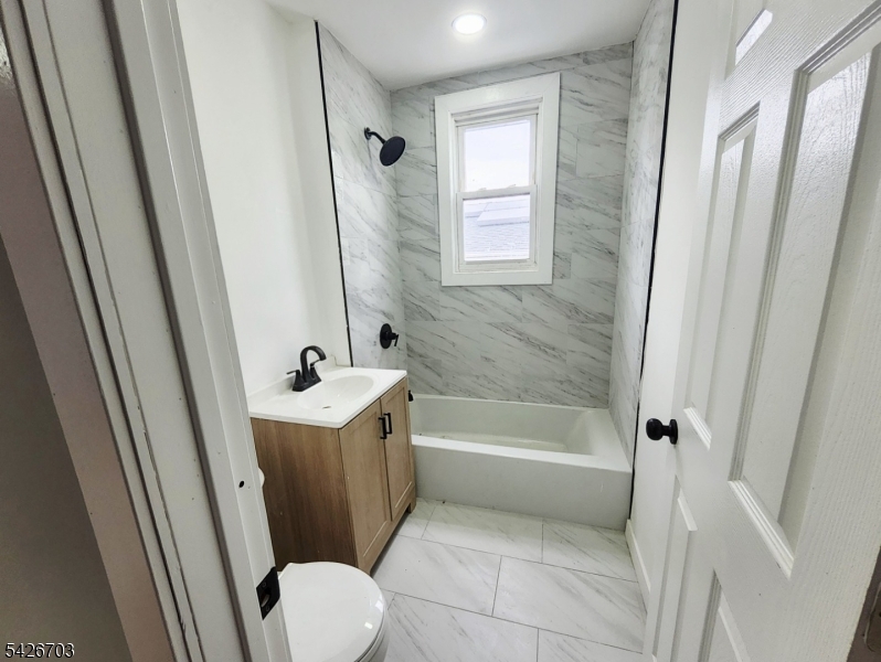 49 Union Place, Unit 3 Irvington, NJ 07111 - Photo 19 of 20 a bathroom with a sink a toilet and a bathtub