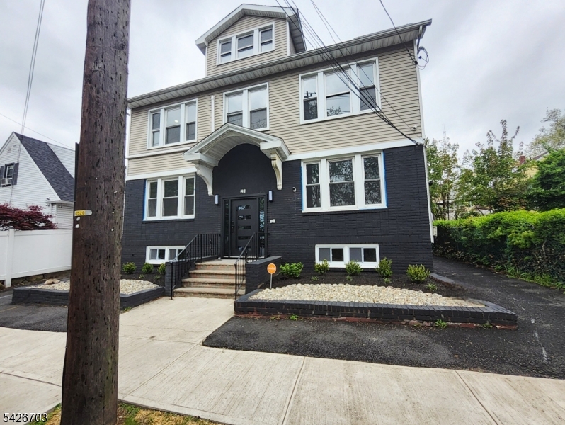 49 Union Place, Unit 3 Irvington, NJ 07111 - Photo 2 of 20 a front view of a house with a yard