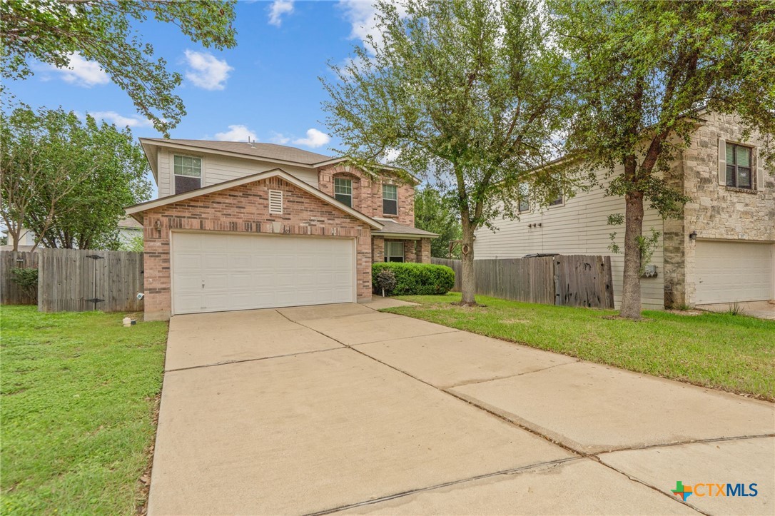 109 Comal Cove Elgin, TX 78621 - Photo 2 of 34 a front view of house with yard