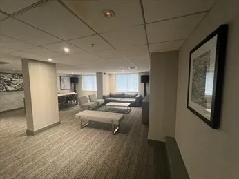 a dining room with furniture and a floor to ceiling window